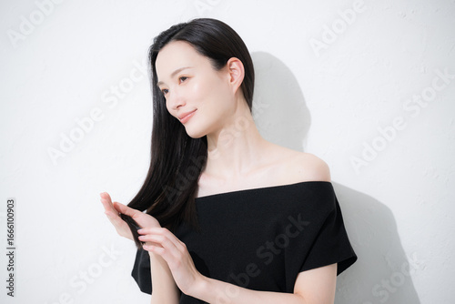 髪の毛の毛先のヘアケアをする女性　トリートメントや枝毛のイメージ