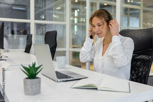 Young business woman working in the office and looking confident