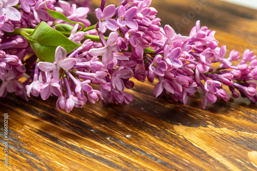 Beautiful spring flowers lilac on a wooden vintage board with place for text. Syringa vulgaris. Happy Mother's Day greetings card.