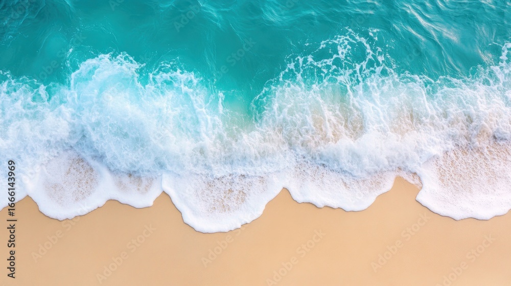 Fototapeta premium Aerial view of turquoise ocean waves breaking on a sandy beach.