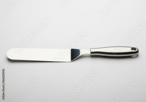 A shiny stainless steel offset spatula with a comfortable black handle, a versatile kitchen utensil for baking, frosting, and cooking, isolated on a clean white background