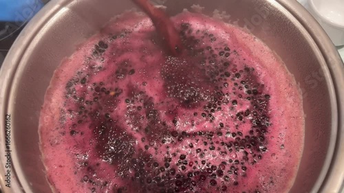 cooking elderberry fruit juice in pot