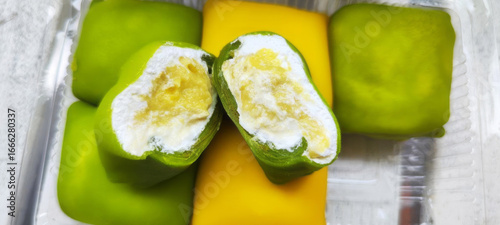 Fotografie Whimsical pandan crepes cradling a luscious cream embrace durian, celebrating Ha