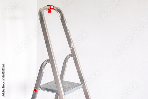 Cuadro en lienzo a stepladder in a bright room ready for renovation