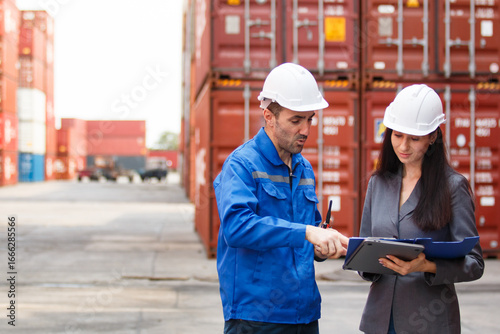 Team of engineers or workers at a container yard discussing seriously and shaking hands to symbolize teamwork and business success.