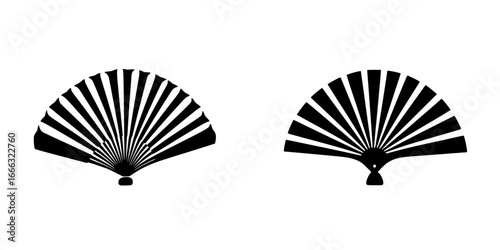 Elegant folding fans displayed in intricate designs for cultural event preparations in warm afternoon light