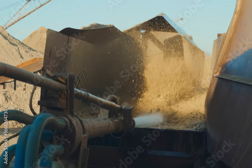 Water jet from the flushing system. Washing of gold bearing sand