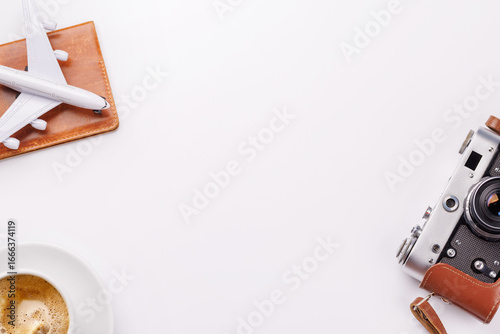 Fotografi Travel-themed flat lay with toy airplane, camera, and coffee