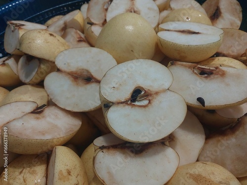 Densely arranged pear slices, featuring fresh texture and seed details