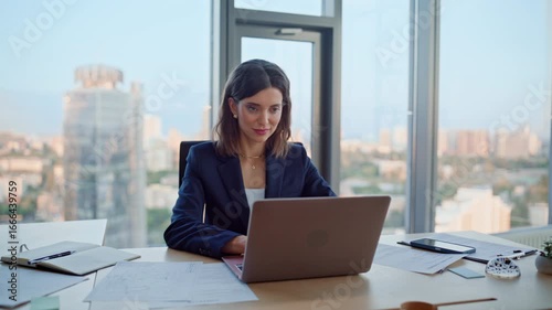 Successful lady looking laptop sitting office desk closeup. Smiling woman