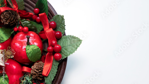 Rustic Christmas composition with holly and fruits