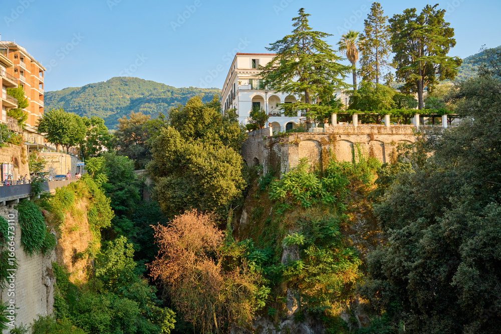 Fototapeta premium Coastal Cliffside Architecture, Trees, Sunny Day