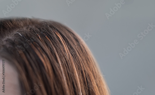Professional hair extension process with thin capsules hair care treatment in a beauty salon by skilled hairstylist