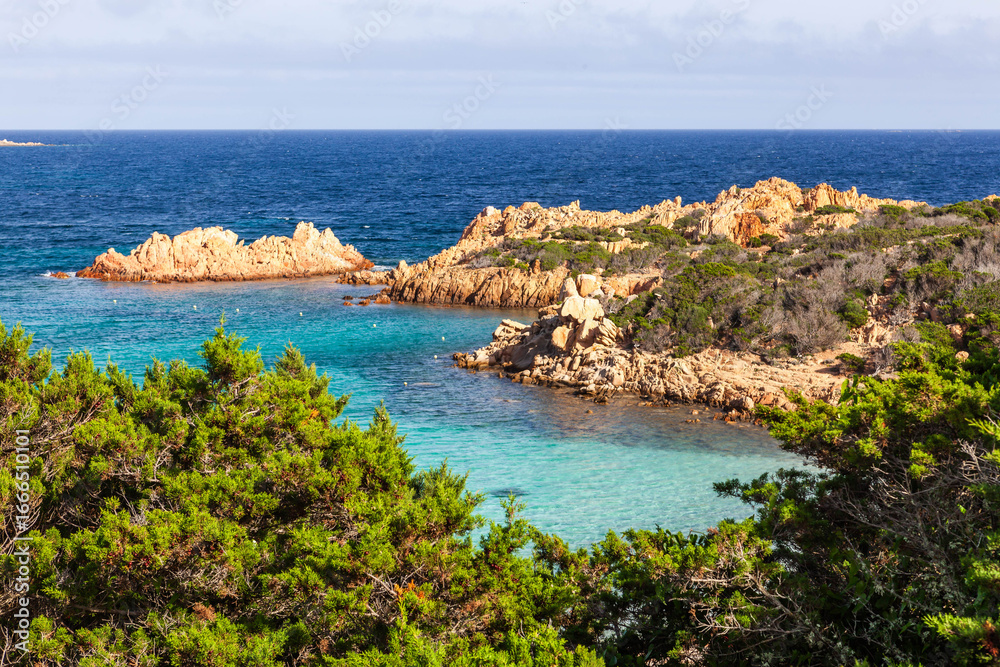 Obraz premium Caprera, Italy. Awesome Turquoise Blue Tyrrhenian sea touches rocky coast of Caprera island in Maddalena archipelago near Sardinia. Gorgeous forest and rocks meet amazing sea.