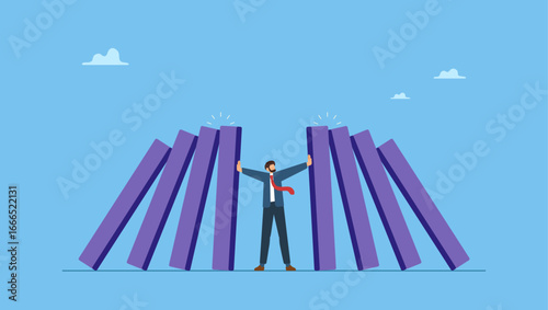 Businessman use his hands to stop domino fall. Crisis management, leadership to manage disaster situation, challenge to overcome difficulty in economic crisis.