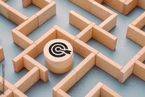 Photos Wooden maze with a target icon block at the center, concept of finding goals thr