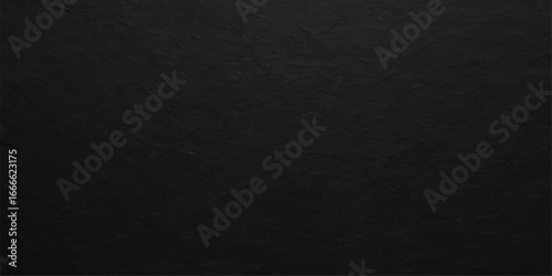 Roughly textured black fabric on a dark paper surface creates a classic black and white macro backdrop