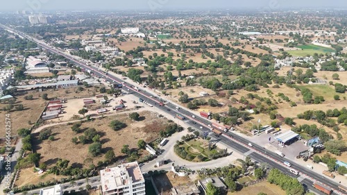 Highway road surrounded by houses  trees with traffic in india  Lucknow city showing development