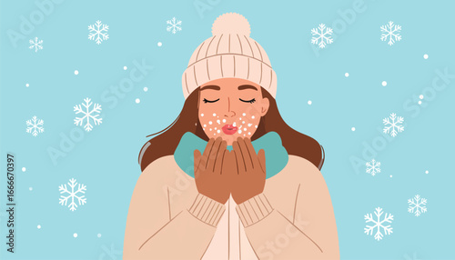 Woman in winter attire blowing snowflakes, creating a cozy and festive seasonal scene.