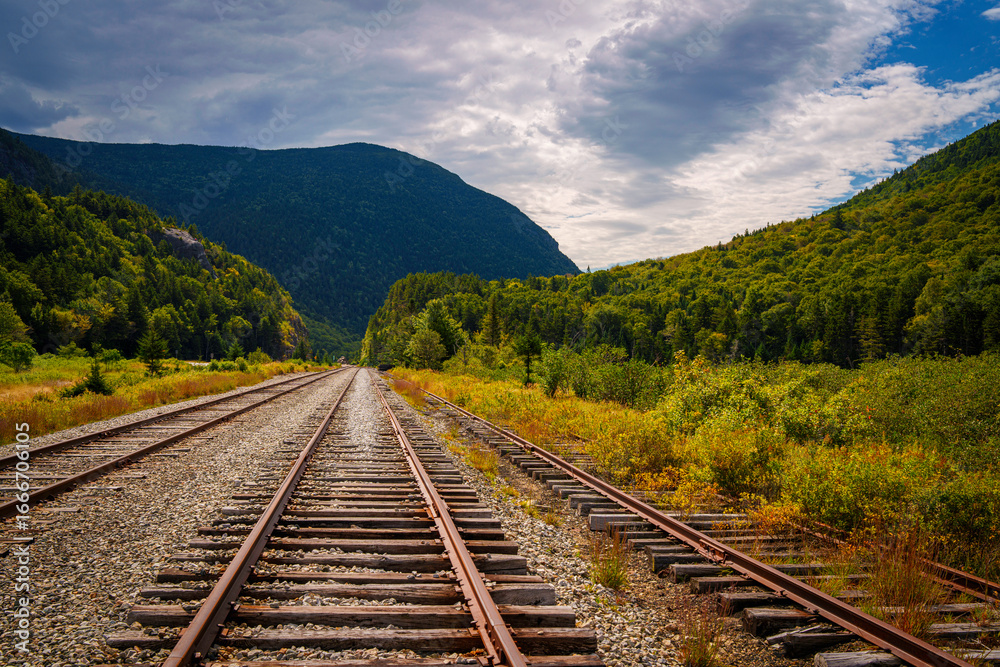 Fototapeta premium Scenic railroad tracks at Crawford Notch Depot running through White Mountain National Forest in Benton Woods and Carroll, New Hampshire, USA