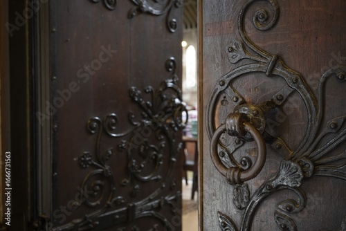 Solid wooden door with ornate iron fittings and door knocker, St Mary Abbot Church, Kensington, London, England, Great Britain