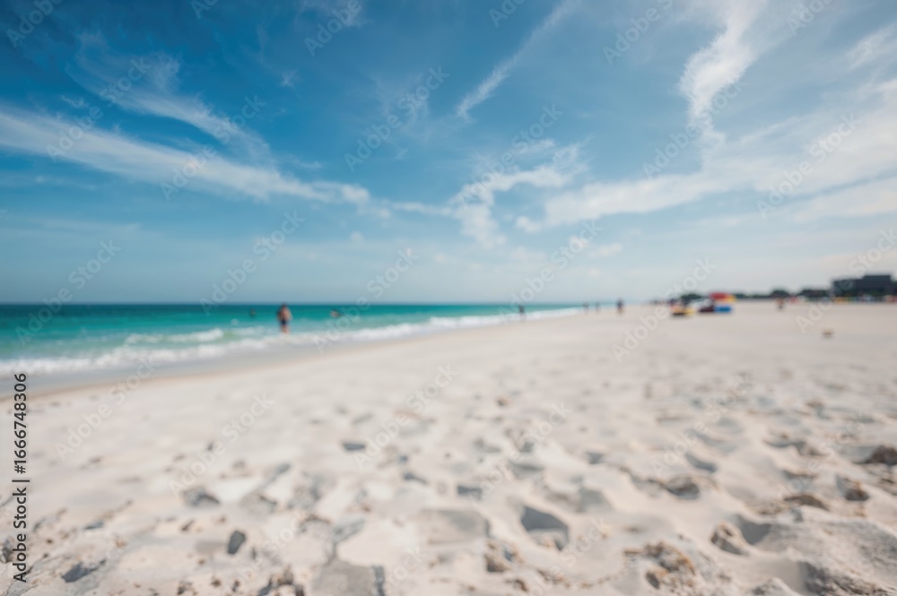 Fototapeta premium Out of focus scene showing a turquoise shore and pale sand