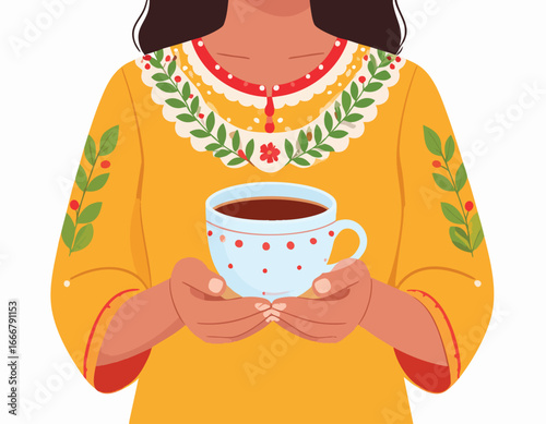Woman in yellow dress holding a cup of tea or coffee with both hands.