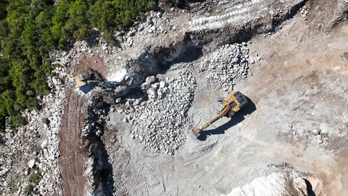 Top view of excavator working on rocky environment