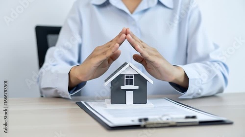 Wallpaper Mural Hands protecting miniature house on paperwork. Torontodigital.ca