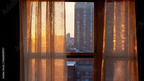 Golden sunset view through sheer curtains