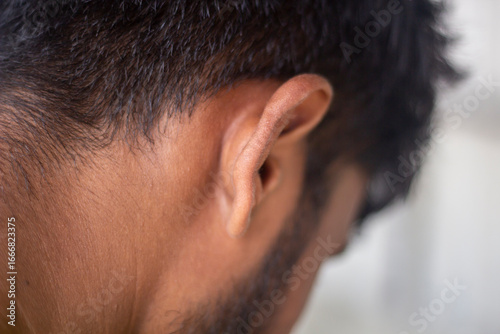 Closeup view of a human ear, showing intricate details of its structure