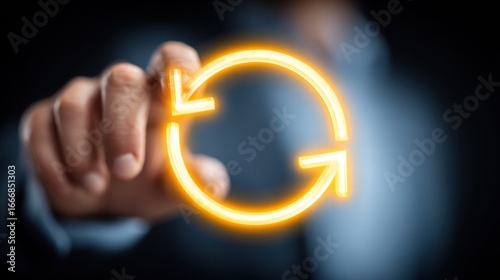 Obraz na płótnie A hand interacting with a glowing, circular arrow icon, representing update or refresh.