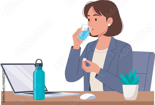 A woman at her desk taking medication with a glass of water.