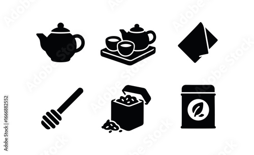 vector solid black filled icons tea set on table (rustic setup): clay teapot earthenware cups wooden tray linen napkin honey dipper loose leaf tin.