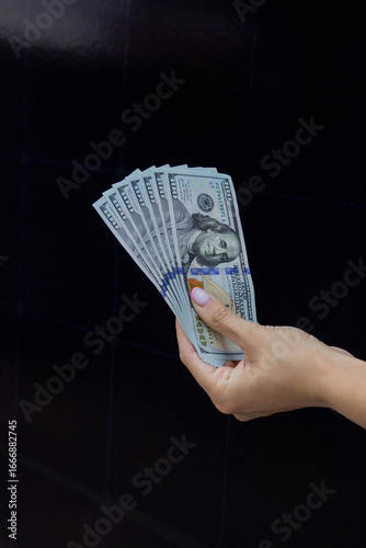 Canvas Print Hand Holding Dollar Bills on Solar Panel