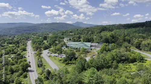 Wallpaper Mural Drone flies along highway toward main entrance of Ben & Jerry's main facility on sunny summer day in Waterbury, Vermont, USA Torontodigital.ca