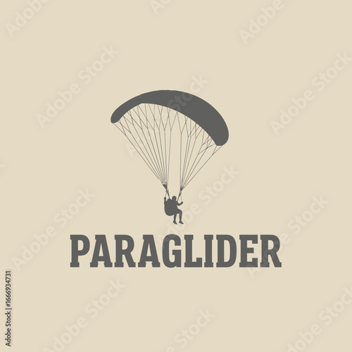 Silhouette of a paraglider soaring through the sky.  Adventure and freedom.