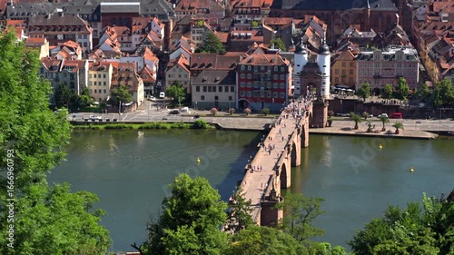 Heidelberg, Germany - June 21, 2025: Wide-angle view of Heidelberg showcasing the old town, castle, and river during spring, featuring lush greenery and historical architecture.