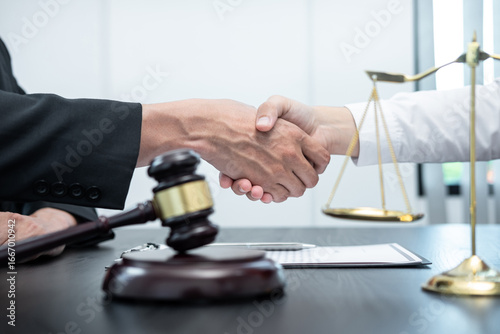 Male lawyer shaking hands with client after good deal negotiation cooperation meeting in courtroom