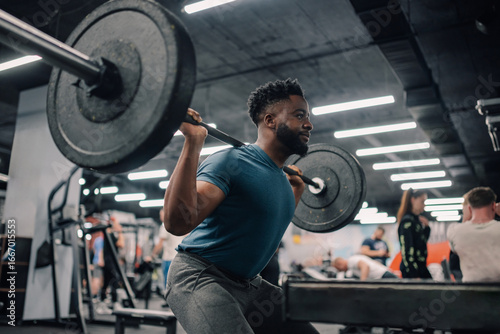 Konstfotografi Determined bodybuilder lifting weights, performing squats in gym