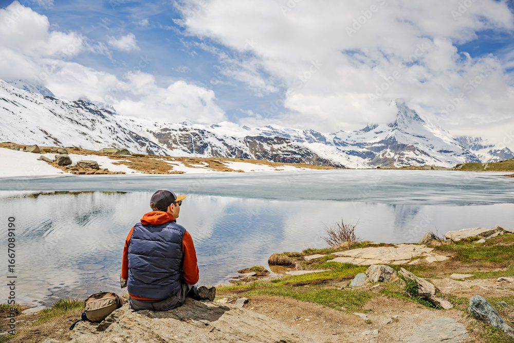 Fototapeta premium Man Relaxing by Mountain Lake