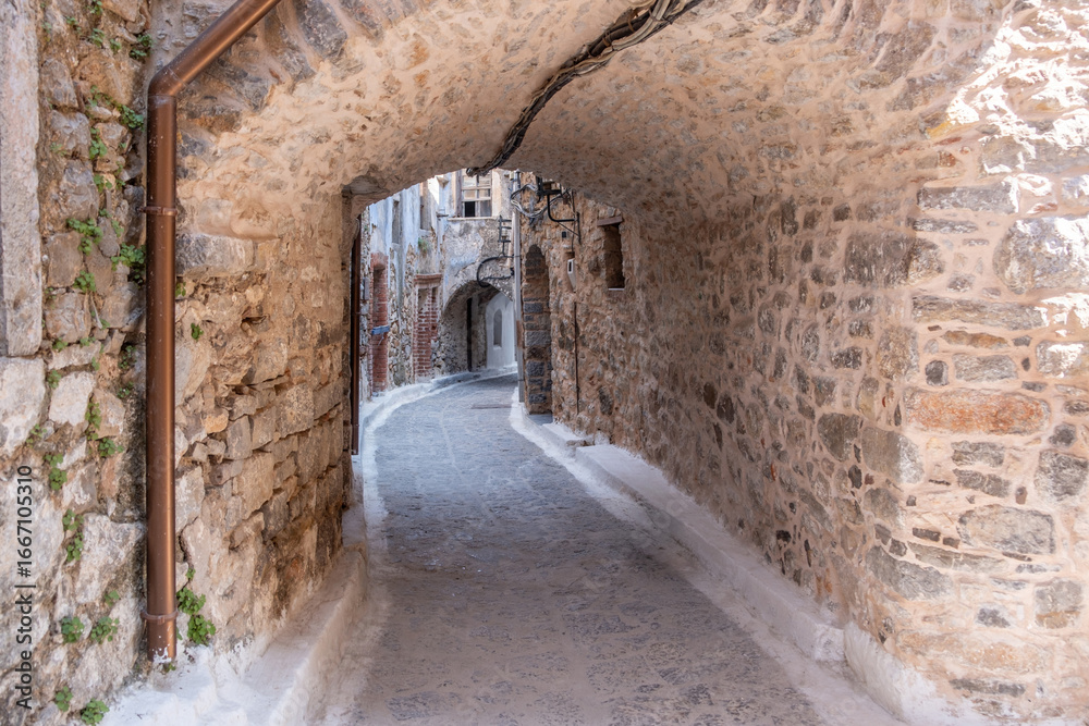 Obraz premium Olympoi medieval village, Chios Island, Greece. Traditional architecture. Narrow alley, stone walls and arch.