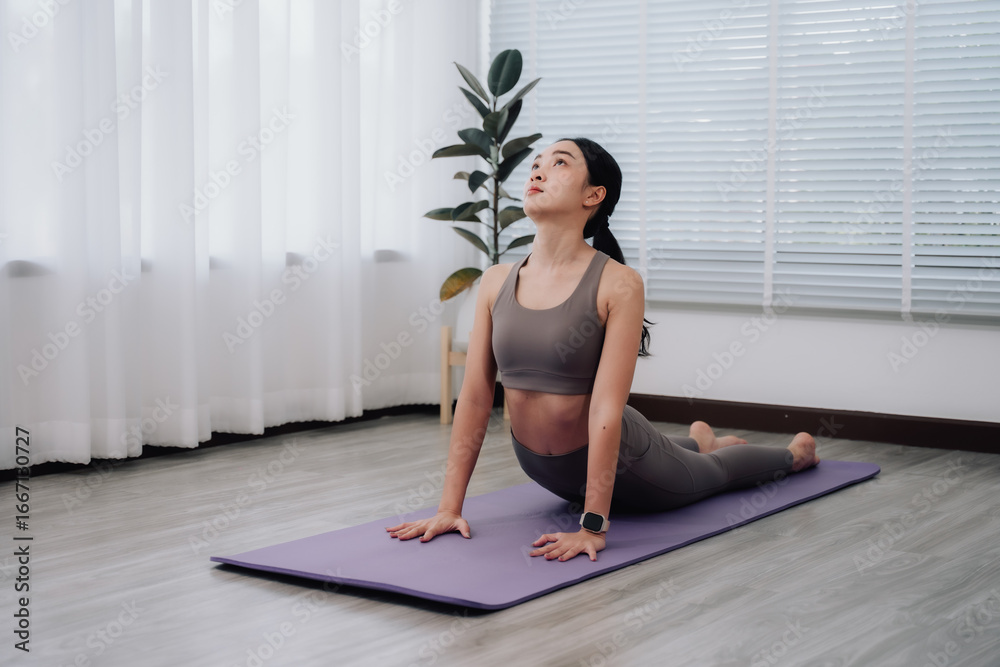 Woman Practicing Cobra Pose in Home Studio Woman Practicing Cobra Pose in Home Studio