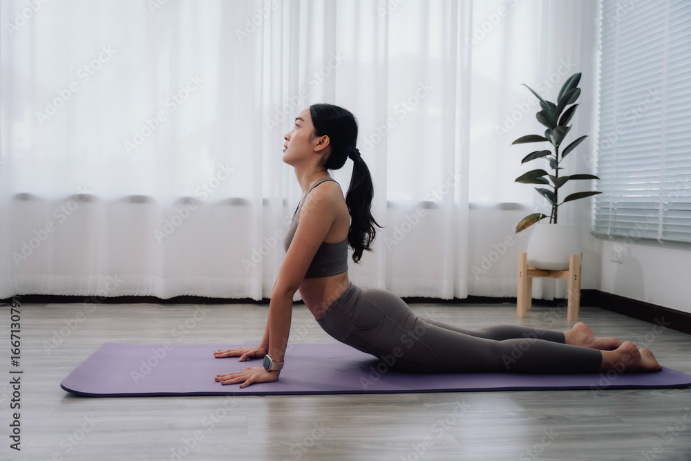 Woman Practicing Cobra Pose at Home Woman Practicing Cobra Pose at Home