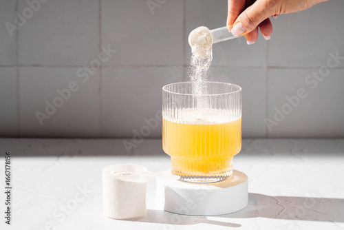 Collagen protein powder in a scoop. Glass of collagen beauty drink. Food supplement.