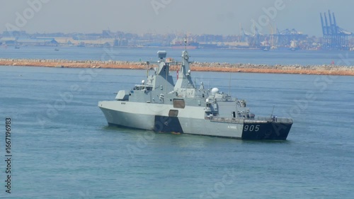 05.04.2025 Alexandria, Egypt - Egyptian navy warship number 905 docked at Alexandria naval base, modern military vessel with radar tower and naval fleet in background.