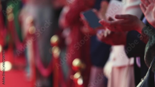 Actors, celebrities and stars on red carpet, guests and fans cheer an clapping hands, welcome, applause and ovation on cinema movie premiere, film festival award ceremony, ropes and golden barriers