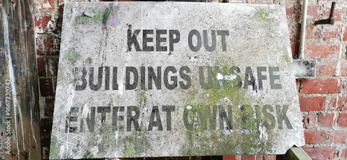 Valokuva Weathered keep out sign, beware danger unsafe building enter at your own risk