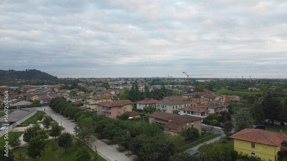 Fototapeta premium Aerial view of the town of Botticino Sera, Brescia, Italy with green fields and from above with a drone
