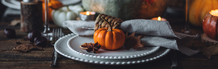 Fall table decoration with pumpkins, wine. Family cozy thanksgiving dinner arrangement indoors at home, wedding elegant decor. Countryside style, simple handmade setting, autumn mood banner